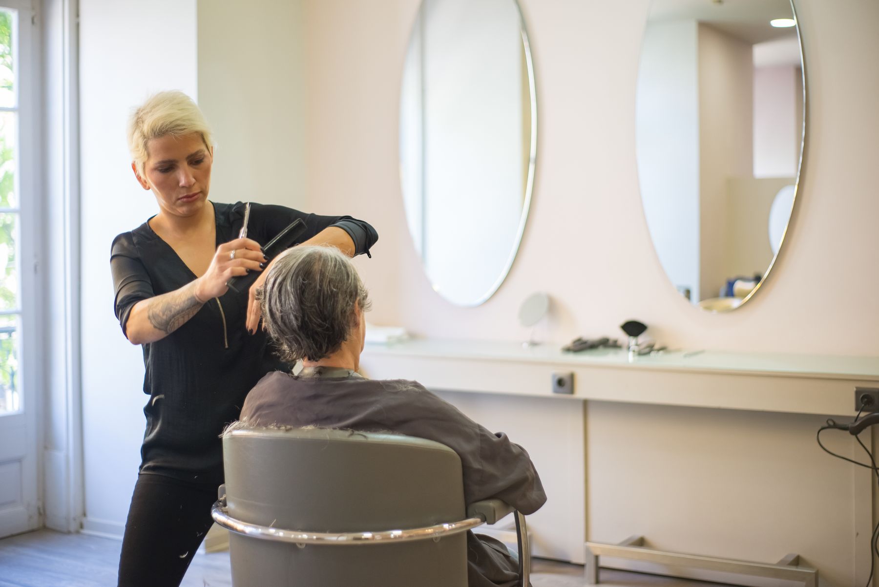 Hairdresser cutting a client's hair